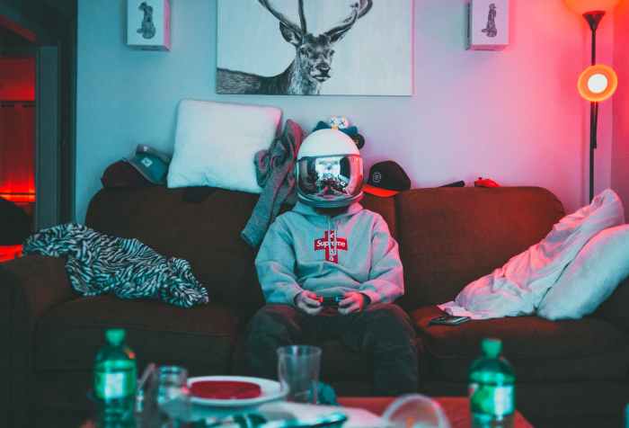 boy in virtual reality helmet playing joystick